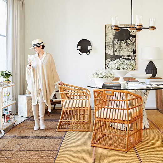 Two diverse influences led Beth to create the Lyford chairs she’s posing with above: Bahamas retreat Lyford Cay and an African chair she spotted in Paris. Other items from her collection shown above include the Sumter chandelier and the Tangier table lamp; the latter was inspired by Ethiopian string jars.
